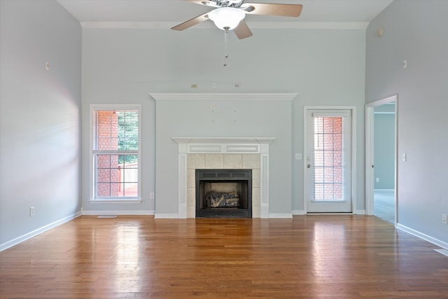 717 Pleasant View Dr, Columbia, TN 38401 - unfurnished living room with high vaulted ceiling, a ceiling fan, wood finished floors, and a tiled fireplace