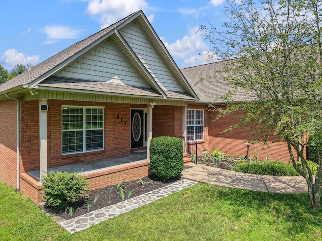 717 Pleasant View Dr, Columbia, TN 38401 - view of front of home with covered porch, a front lawn, roof with shingles, and brick siding