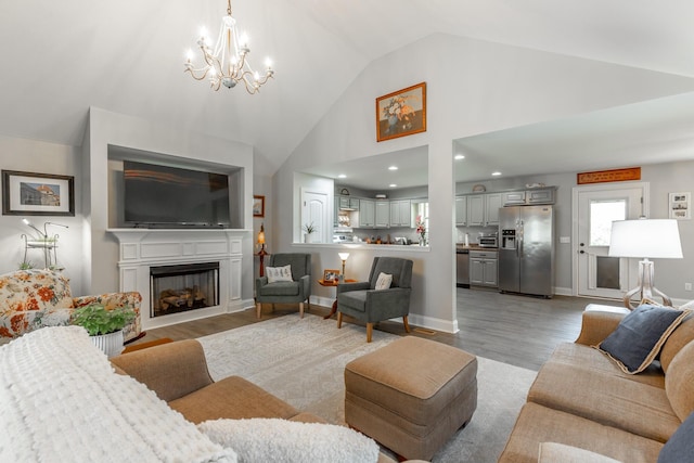 30 Hunting Ridge Cir, Rock Spring, GA 30739 - living area with a chandelier, vaulted ceiling, a fireplace, light wood-style floors, and recessed lighting
