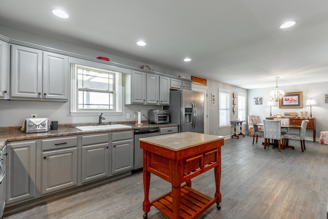 30 Hunting Ridge Cir, Rock Spring, GA 30739 - kitchen with stainless steel appliances, gray cabinets, light wood-style flooring, recessed lighting, and a chandelier