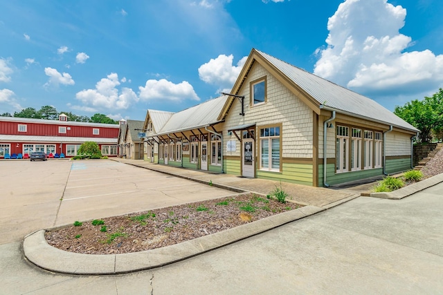 30 Hunting Ridge Cir, Rock Spring, GA 30739 - view of side of home featuring a metal roof and uncovered parking