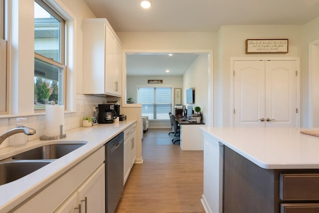 1727 Humphreys Gln, Spring Hill, TN 37174 - kitchen featuring dishwasher, light wood-style floors, white cabinets, backsplash, and light countertops