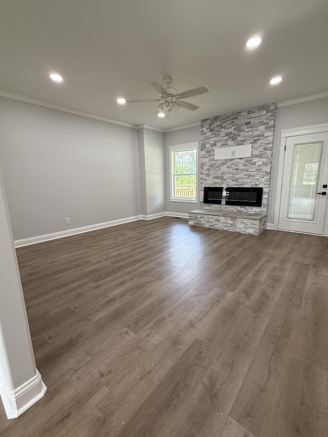 711 Johnson St, Clarksville, TN 37043 - unfurnished living room with ornamental molding, a ceiling fan, a stone fireplace, dark wood finished floors, and recessed lighting