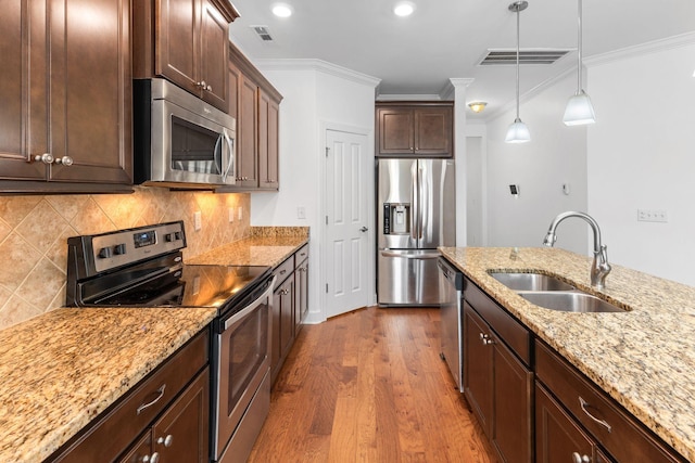 526 Sydenham Dr, Franklin, TN 37064 - kitchen with stainless steel appliances, dark wood-style flooring, ornamental molding, pendant lighting, and dark brown cabinets