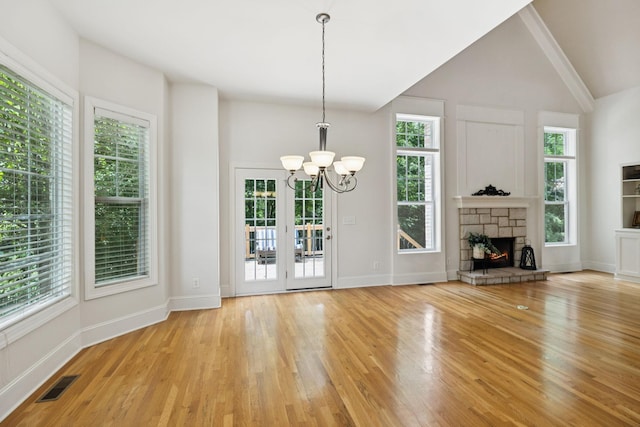 4019 Fremantle Cir, Spring Hill, TN 37174 - unfurnished living room featuring a chandelier, healthy amount of natural light, wood finished floors, vaulted ceiling, and a fireplace