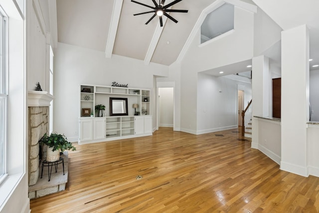 4019 Fremantle Cir, Spring Hill, TN 37174 - unfurnished living room featuring high vaulted ceiling, ceiling fan, light wood-type flooring, beamed ceiling, and stairway