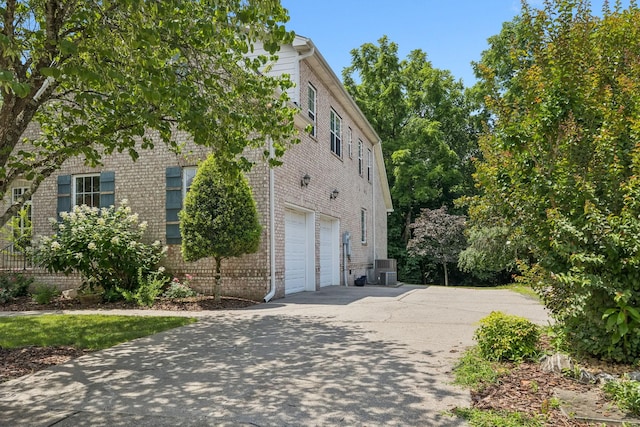 4019 Fremantle Cir, Spring Hill, TN 37174 - view of home's exterior featuring an attached garage, brick siding, and driveway