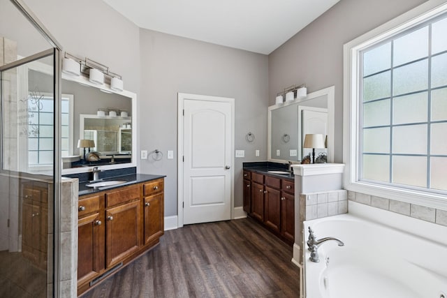 4019 Fremantle Cir, Spring Hill, TN 37174 - full bathroom with a stall shower, wood finished floors, two vanities, and a bath