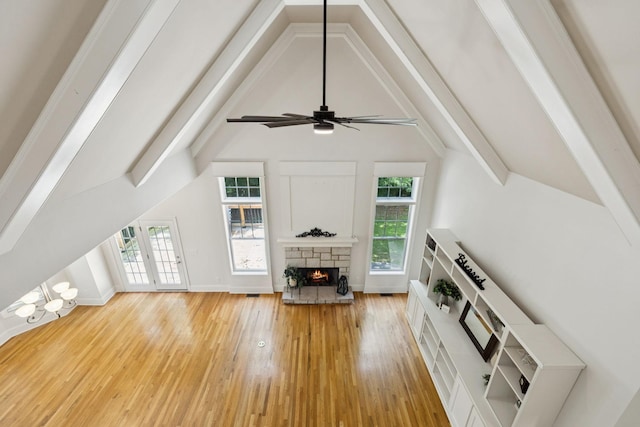4019 Fremantle Cir, Spring Hill, TN 37174 - living area with a stone fireplace, beamed ceiling, light wood-style flooring, healthy amount of natural light, and a chandelier