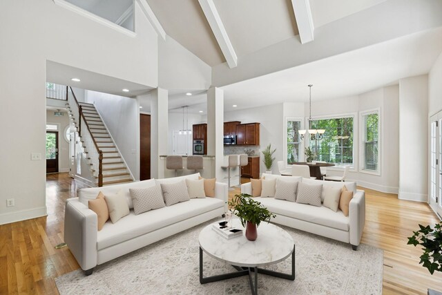 4019 Fremantle Cir, Spring Hill, TN 37174 - living area featuring a chandelier, light wood-style flooring, stairs, healthy amount of natural light, and beamed ceiling