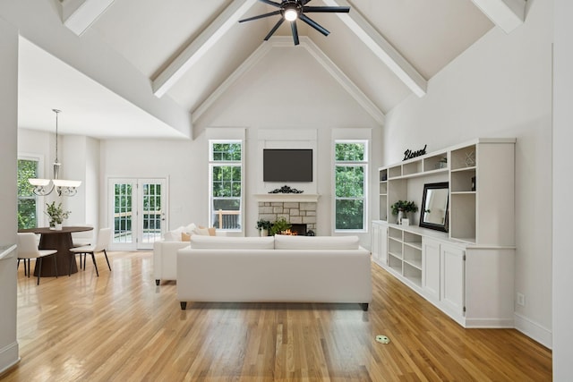 4019 Fremantle Cir, Spring Hill, TN 37174 - living area featuring light wood-style flooring, a stone fireplace, a chandelier, beam ceiling, and a ceiling fan