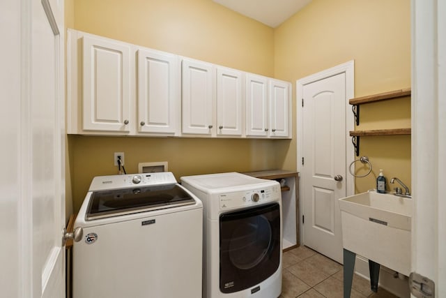 4019 Fremantle Cir, Spring Hill, TN 37174 - laundry area featuring cabinet space, independent washer and dryer, and light tile patterned floors