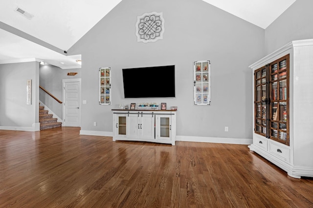1021 Tulip Dr, Ashland City, TN 37015 - unfurnished living room with high vaulted ceiling, stairs, and wood finished floors