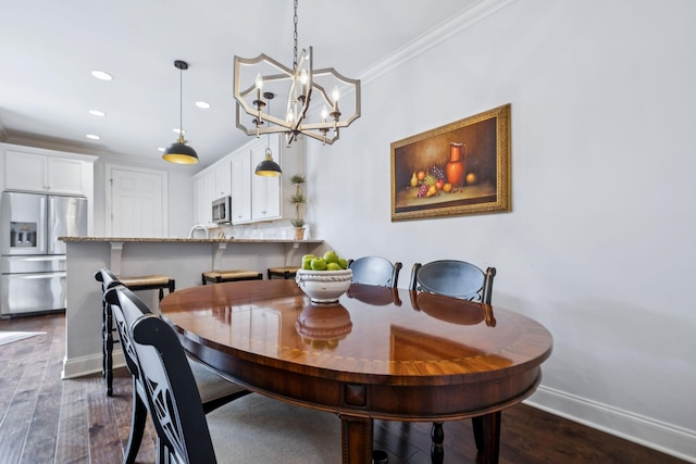 9020 Wenlock Ln, Franklin, TN 37064 - dining room featuring dark wood-style flooring, recessed lighting, ornamental molding, and a chandelier