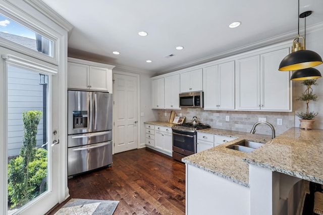 9020 Wenlock Ln, Franklin, TN 37064 - kitchen featuring stainless steel appliances, a peninsula, white cabinetry, backsplash, and ornamental molding