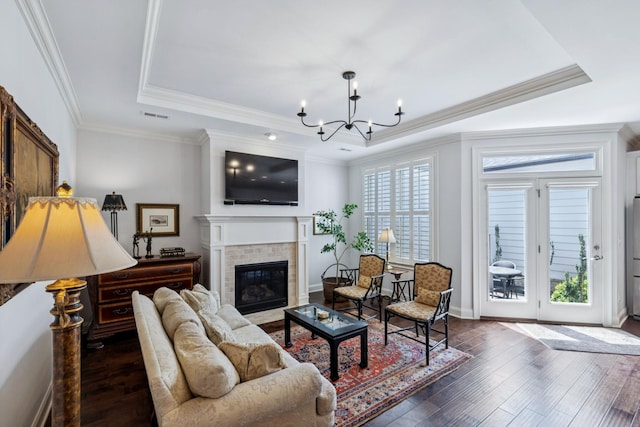 9020 Wenlock Ln, Franklin, TN 37064 - living area with a raised ceiling, a chandelier, dark wood finished floors, a brick fireplace, and ornamental molding