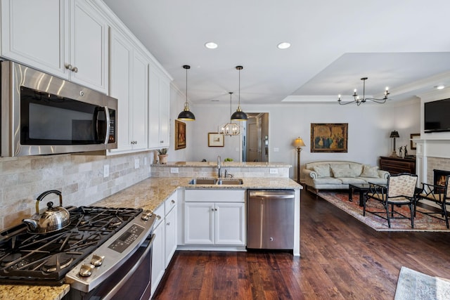 9020 Wenlock Ln, Franklin, TN 37064 - kitchen featuring stainless steel appliances, a chandelier, a peninsula, white cabinetry, and recessed lighting