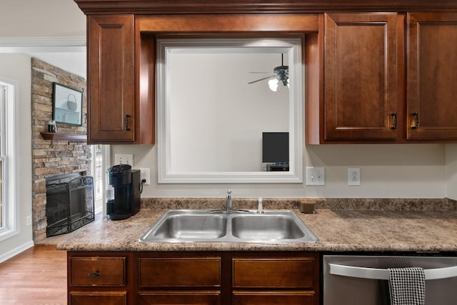 4328 Monticello Trce, Adams, TN 37010 - kitchen featuring dishwasher, ceiling fan, wood finished floors, and a fireplace