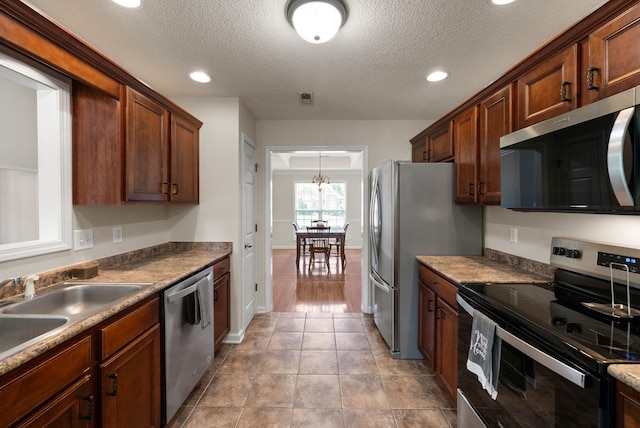 4328 Monticello Trce, Adams, TN 37010 - kitchen featuring stainless steel appliances, a textured ceiling, recessed lighting, and light tile patterned floors