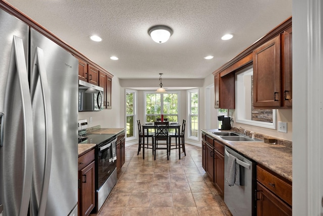 4328 Monticello Trce, Adams, TN 37010 - kitchen with stainless steel appliances, a textured ceiling, recessed lighting, and decorative light fixtures