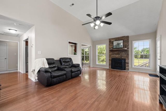 4328 Monticello Trce, Adams, TN 37010 - living area with a fireplace, wood finished floors, high vaulted ceiling, and a ceiling fan