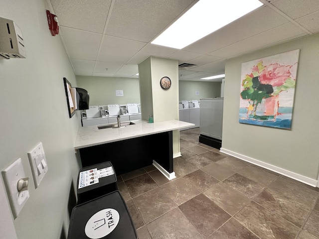4215 Harding Pike Unit 903, Nashville, TN 37205 - bathroom featuring washing machine and dryer, a paneled ceiling, vanity, and stone finish flooring