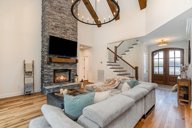 3515 Shellmans Dr, Murfreesboro, TN 37129 - living area featuring hardwood / wood-style flooring, stairway, a towering ceiling, french doors, and a stone fireplace
