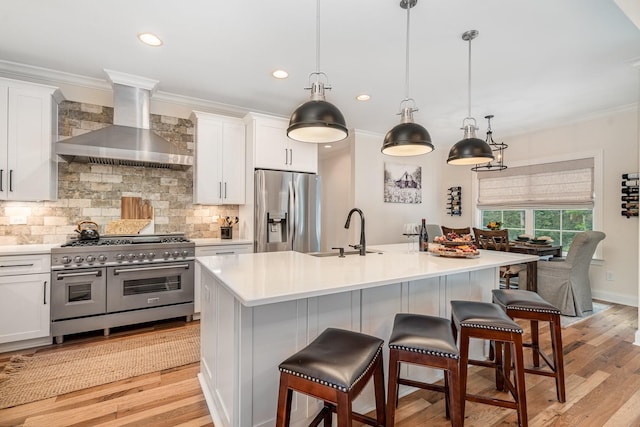 3515 Shellmans Dr, Murfreesboro, TN 37129 - kitchen featuring stainless steel appliances, wall chimney range hood, white cabinetry, decorative backsplash, and light wood finished floors