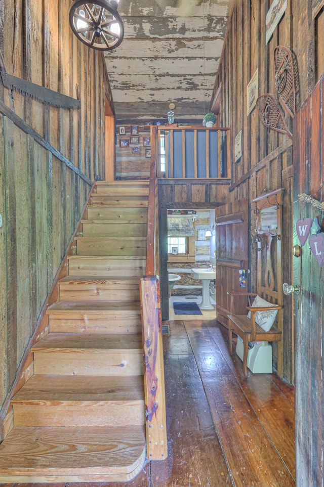 569 Hogans Branch Rd, Hendersonville, TN 37075 - staircase featuring wood walls, high vaulted ceiling, and hardwood / wood-style floors