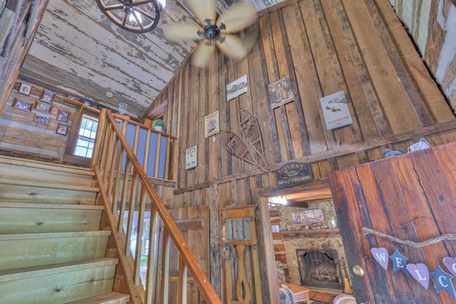 569 Hogans Branch Rd, Hendersonville, TN 37075 - stairs with wooden walls, high vaulted ceiling, a stone fireplace, and wooden ceiling