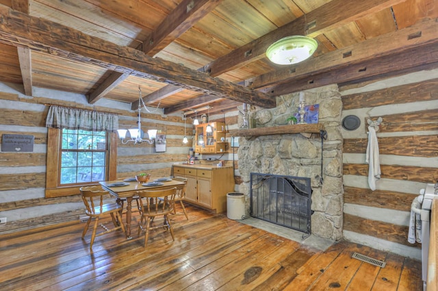 569 Hogans Branch Rd, Hendersonville, TN 37075 - dining room with light wood-style floors, a wooden ceiling with exposed beams, a stone fireplace, wood walls, and a chandelier