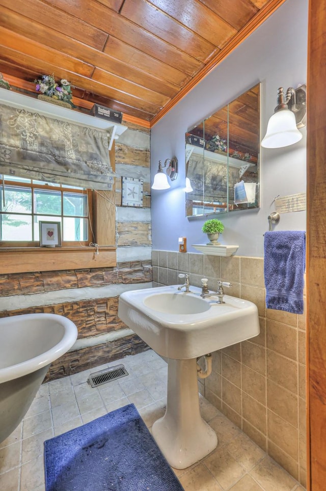 569 Hogans Branch Rd, Hendersonville, TN 37075 - bathroom featuring wood ceiling, crown molding, tile walls, tile patterned floors, and a wainscoted wall