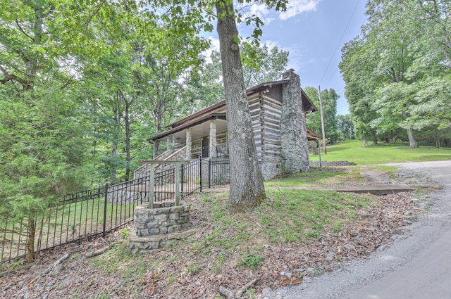569 Hogans Branch Rd, Hendersonville, TN 37075 - view of property exterior featuring a chimney and covered porch