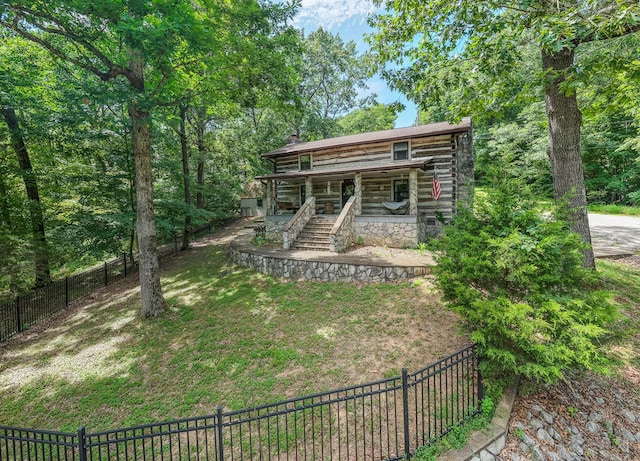 569 Hogans Branch Rd, Hendersonville, TN 37075 - view of front of home with a fenced backyard, a porch, log exterior, stairway, and a chimney