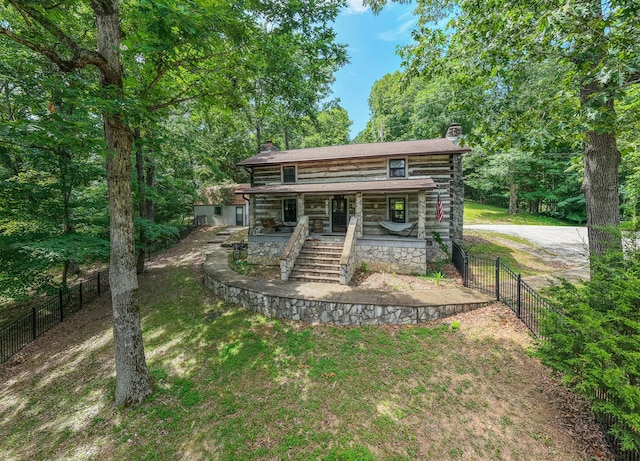 569 Hogans Branch Rd, Hendersonville, TN 37075 - view of front of home with a chimney, covered porch, and log siding