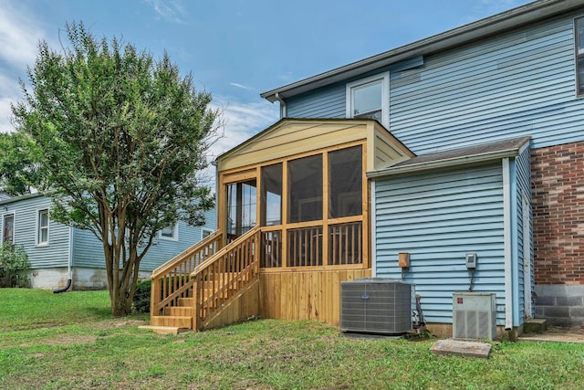 1221 Katie Ave Unit A, Nashville, TN 37207 - rear view of property featuring a sunroom, a lawn, stairs, and brick siding