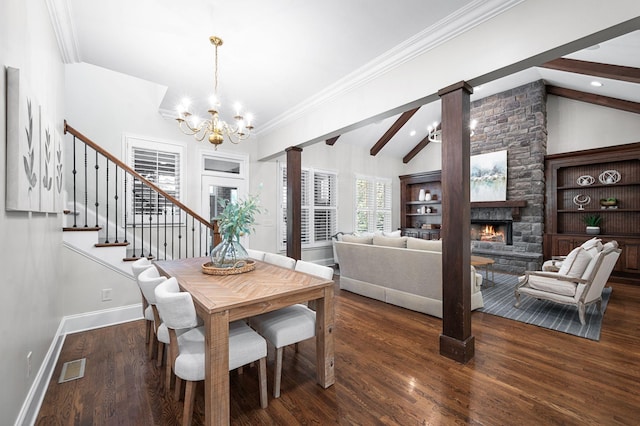 1313 Jewell Ave, Franklin, TN 37064 - dining room with a chandelier, a fireplace, wood finished floors, decorative columns, and stairway