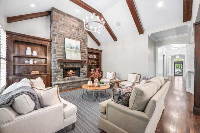 1313 Jewell Ave, Franklin, TN 37064 - living room featuring arched walkways, wood finished floors, a stone fireplace, a chandelier, and recessed lighting