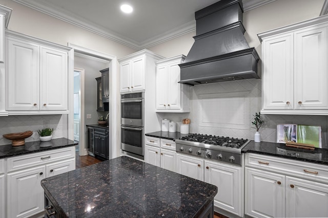 1313 Jewell Ave, Franklin, TN 37064 - kitchen with appliances with stainless steel finishes, custom range hood, white cabinets, ornamental molding, and tasteful backsplash