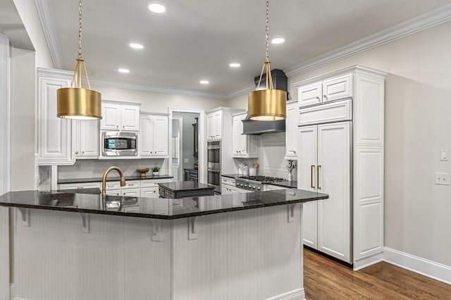 1313 Jewell Ave, Franklin, TN 37064 - kitchen featuring built in appliances, dark wood-style flooring, white cabinets, a breakfast bar, and crown molding