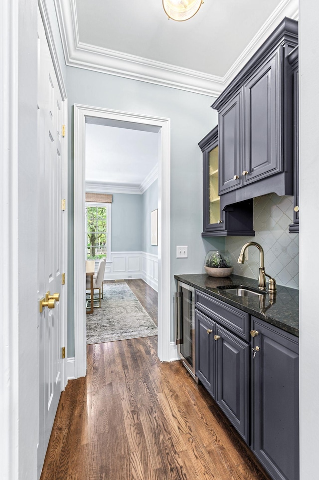 1313 Jewell Ave, Franklin, TN 37064 - bar area with wine cooler, dark wood-type flooring, crown molding, tasteful backsplash, and a wainscoted wall