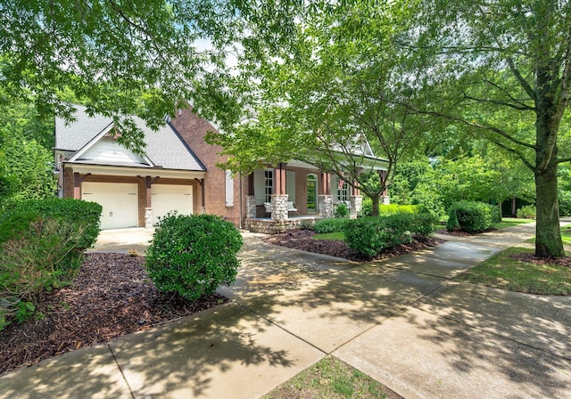 1313 Jewell Ave, Franklin, TN 37064 - view of property hidden behind natural elements with a porch, brick siding, an attached garage, and driveway