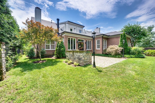 1313 Jewell Ave, Franklin, TN 37064 - rear view of property featuring a balcony, a patio, brick siding, a yard, and a chimney