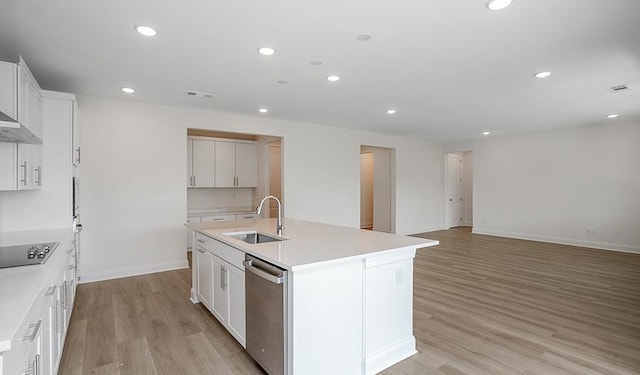 2901 Windstone Trl, Columbia, TN 38401 - kitchen featuring stainless steel dishwasher, an island with sink, light wood-style floors, recessed lighting, and white cabinetry
