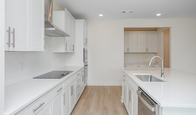 2901 Windstone Trl, Columbia, TN 38401 - kitchen with wall chimney range hood, stainless steel appliances, recessed lighting, light countertops, and light wood finished floors