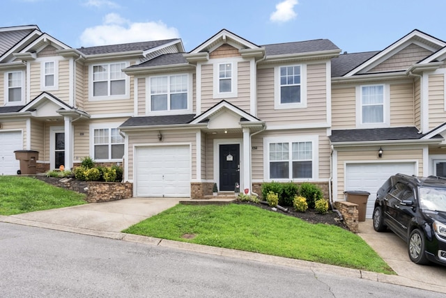 1515 Bridgecrest Dr Unit 408, Antioch, TN 37013 - townhome / multi-family property featuring concrete driveway, a garage, a front lawn, and stone siding