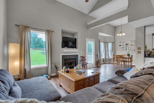 1515 Bridgecrest Dr Unit 408, Antioch, TN 37013 - living area with plenty of natural light, wood finished floors, high vaulted ceiling, a fireplace, and a chandelier