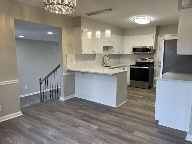 621 Buck Ln, Murfreesboro, TN 37129 - kitchen with appliances with stainless steel finishes, a peninsula, white cabinets, and dark wood-style floors