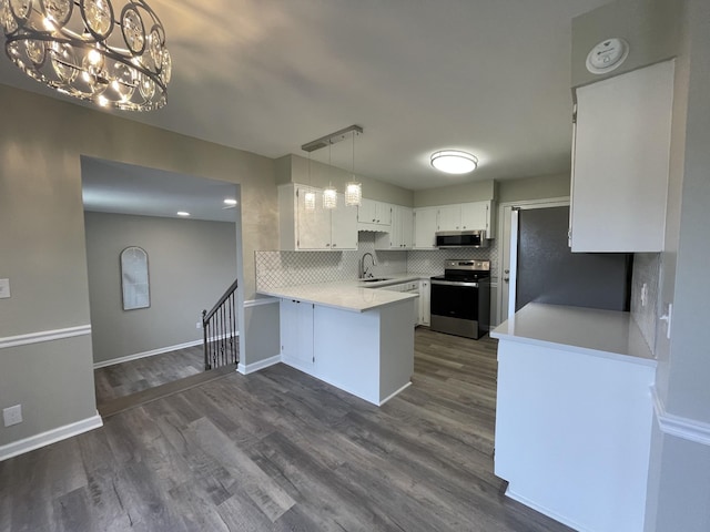 621 Buck Ln, Murfreesboro, TN 37129 - kitchen featuring appliances with stainless steel finishes, a peninsula, light countertops, and backsplash