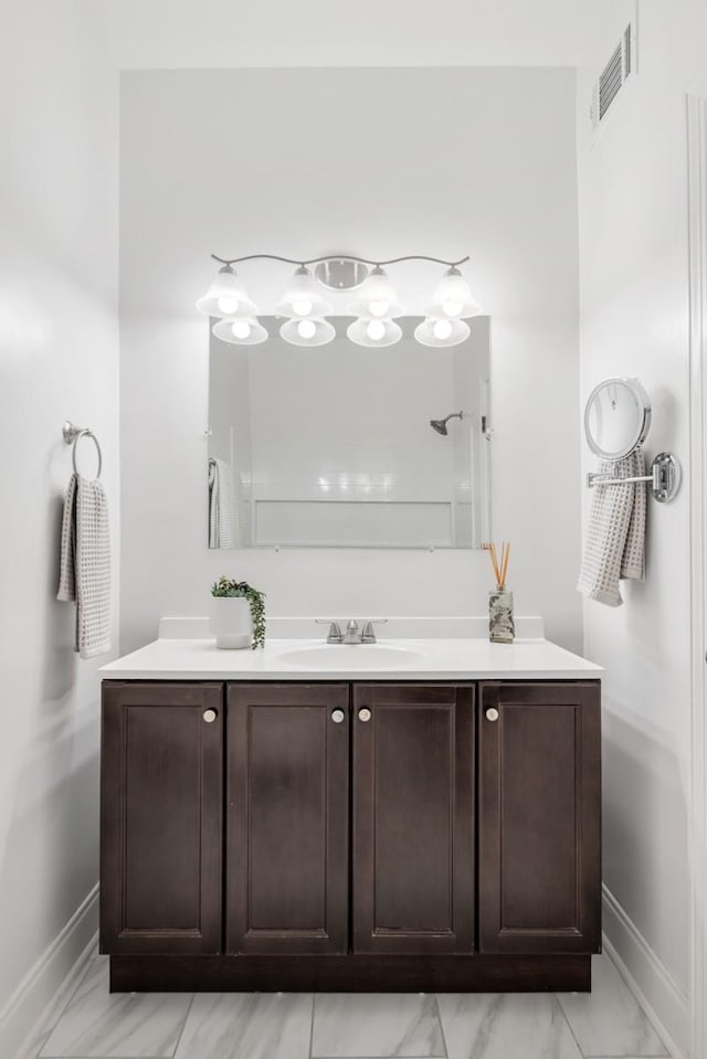 416 Sloan Rd, Nashville, TN 37209 - bathroom featuring vanity, marble look tile flooring, and a shower